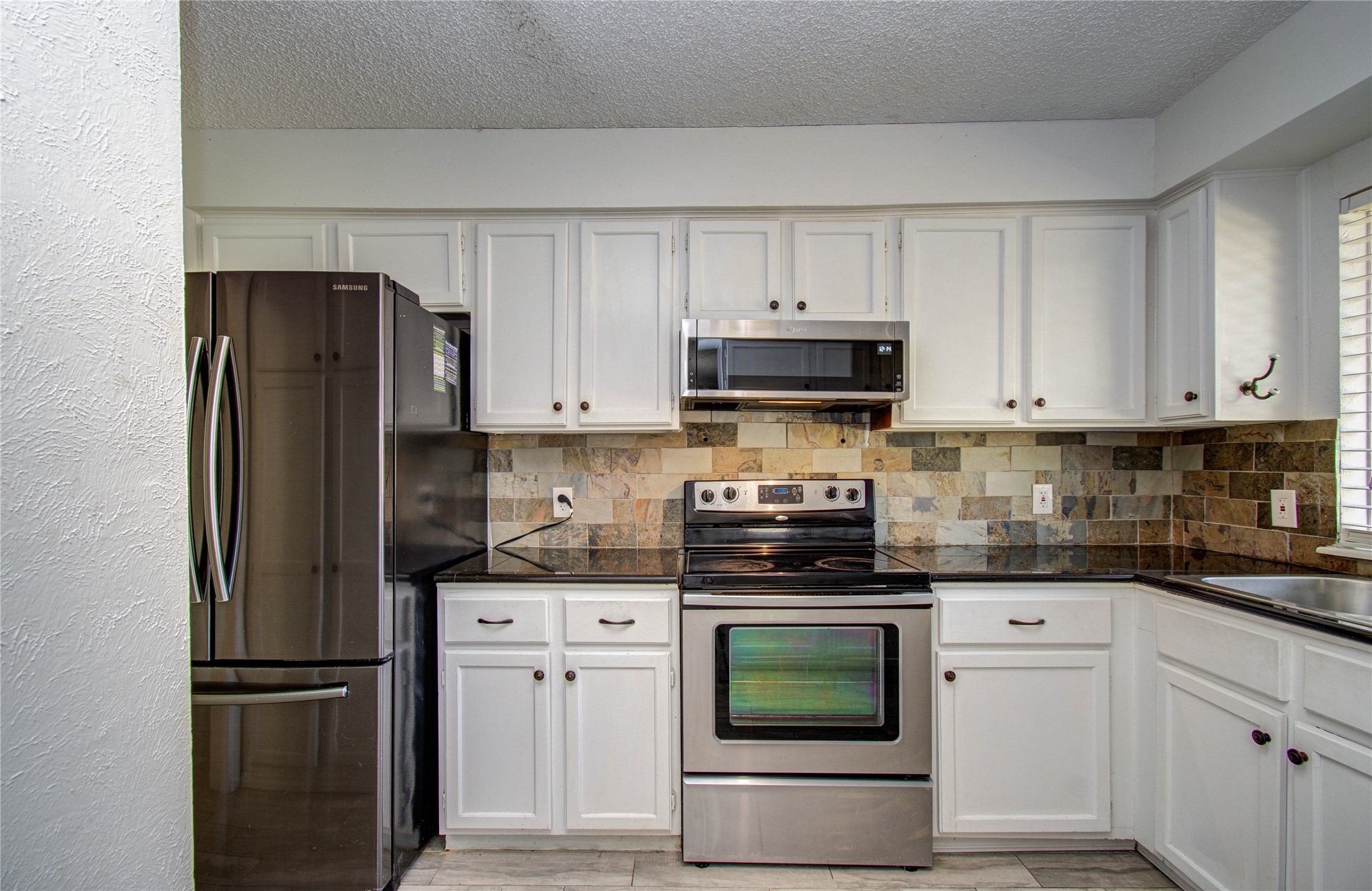 5311 Sweetwind Lane Spring, TX 77373 - Photo 5 of 18 a kitchen with cabinets and stainless steel appliances