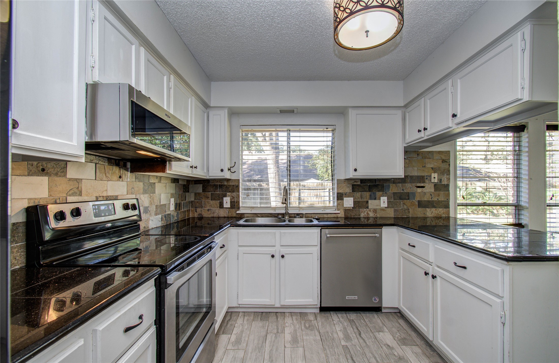 5311 Sweetwind Lane Spring, TX 77373 - Photo 6 of 18 a kitchen with stainless steel appliances a sink a stove and cabinets