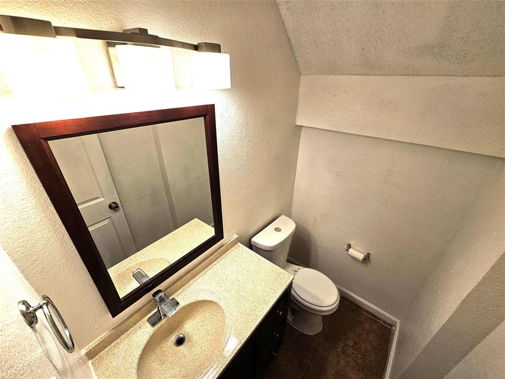 724 Bluebonnet Drive, Unit A Keller, TX 76248 - Photo 15 of 27 a bathroom with a toilet sink and mirror