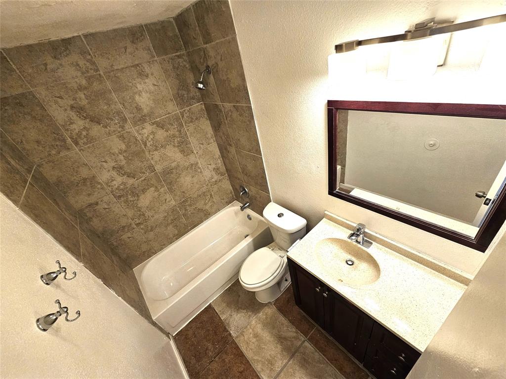 724 Bluebonnet Drive, Unit A Keller, TX 76248 - Photo 22 of 27 a bathroom with a granite countertop sink toilet and shower