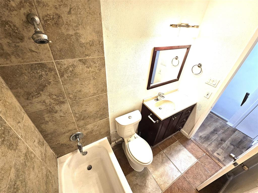 724 Bluebonnet Drive, Unit A Keller, TX 76248 - Photo 23 of 27 a bathroom with a toilet sink and mirror