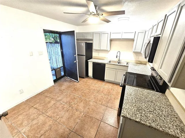 a view of a livingroom with a dishwasher cabinets and wooden floor