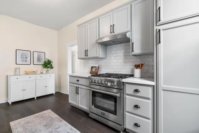 a kitchen with cabinets a stove and a white oven