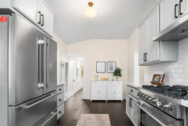 a kitchen with a stove and white cabinets