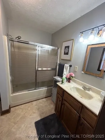 a bathroom with a sink mirror toilet and shower