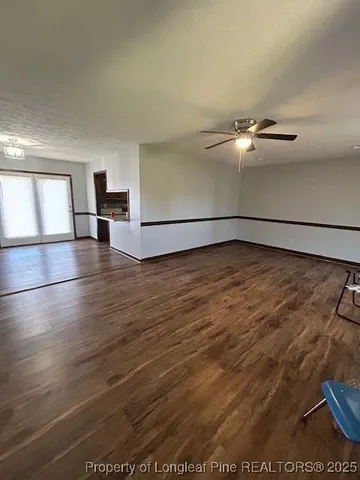 a view of a room with wooden floor