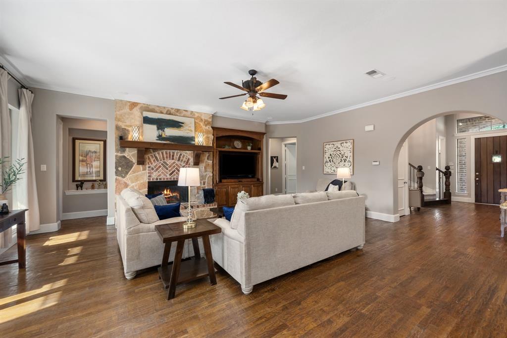 11571 Cody Lane Frisco, TX 75033 - Photo 4 of 39 a living room with furniture and a fireplace