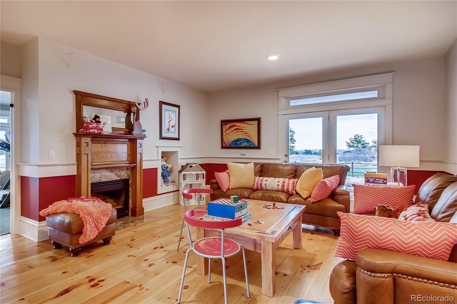 727 East Rim Road Franktown, CO 80116 - Photo 15 of 40 a living room with fireplace furniture and a window
