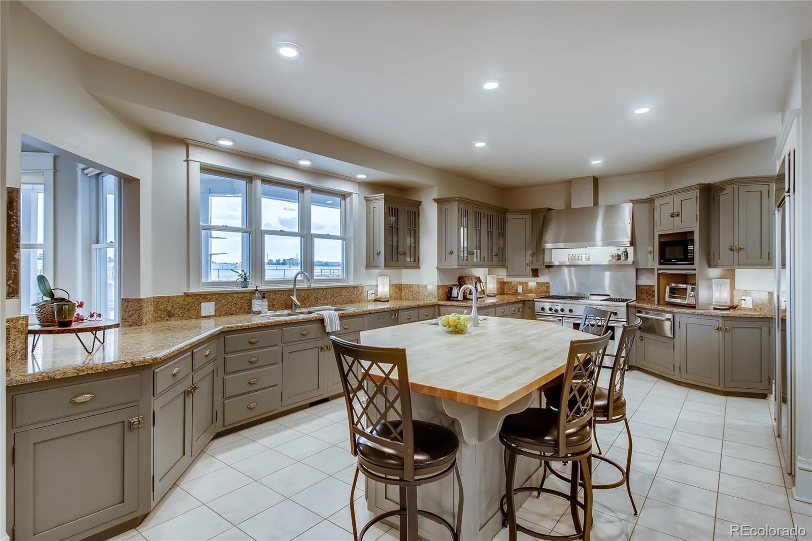 727 East Rim Road Franktown, CO 80116 - Photo 16 of 40 a kitchen with a dining table chairs and sink