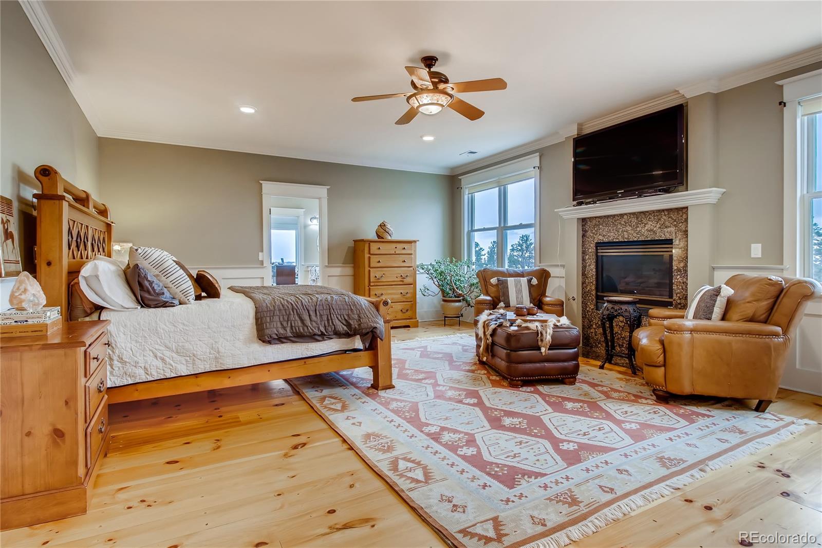 727 East Rim Road Franktown, CO 80116 - Photo 18 of 40 a living room with furniture and a fireplace