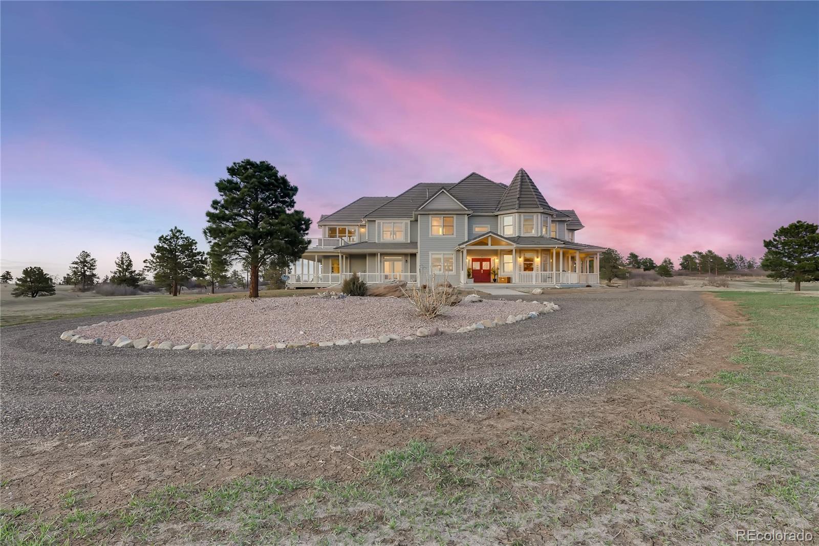 727 East Rim Road Franktown, CO 80116 - Photo 2 of 40 a front view of a house with a yard and a large tree