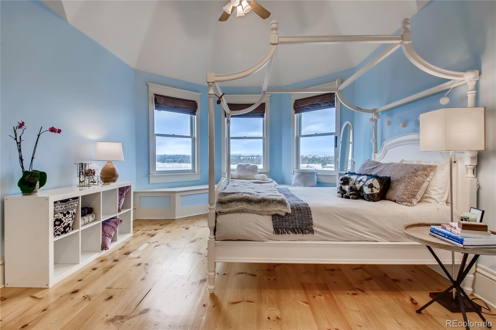 727 East Rim Road Franktown, CO 80116 - Photo 21 of 40 a spacious bedroom with a bed and a dresser in it