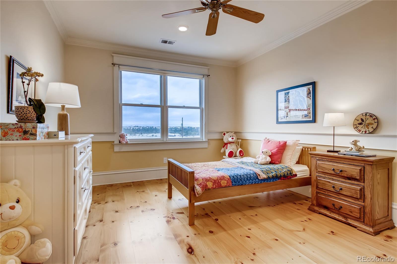727 East Rim Road Franktown, CO 80116 - Photo 25 of 40 a bedroom with a bed and a dresser