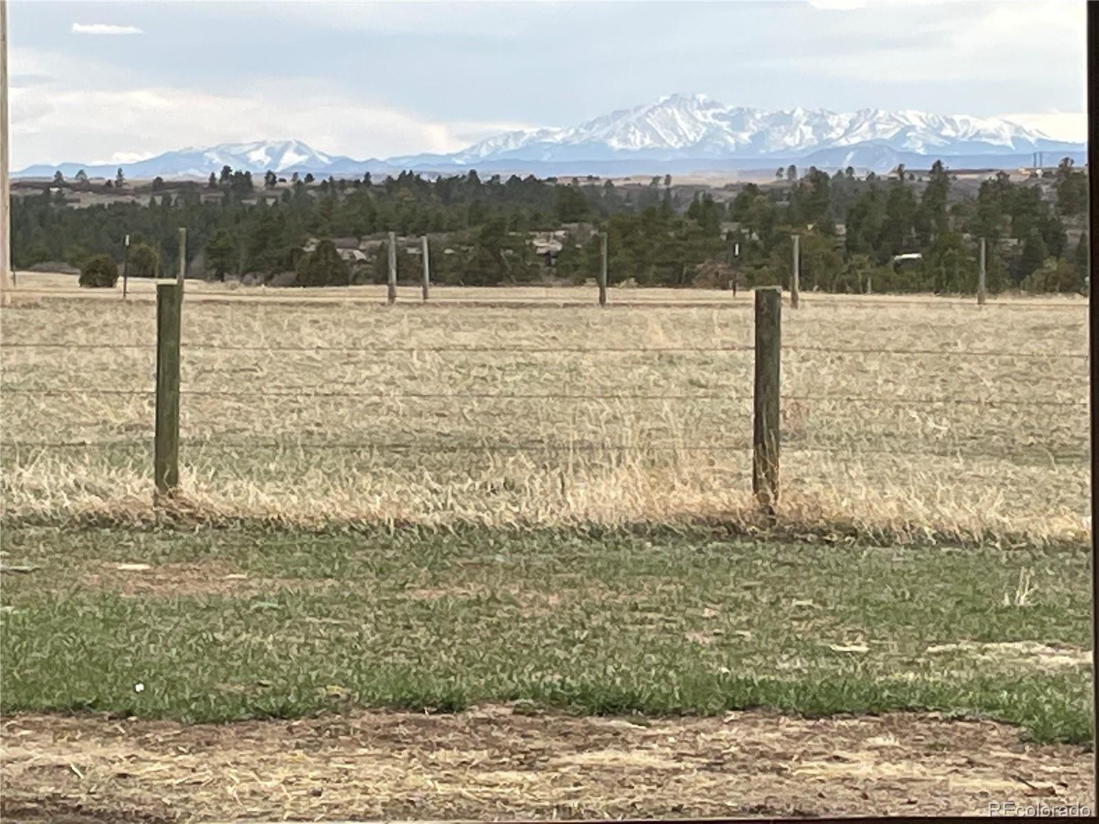 727 East Rim Road Franktown, CO 80116 - Photo 32 of 40 a view of a lake with a mountain in the background