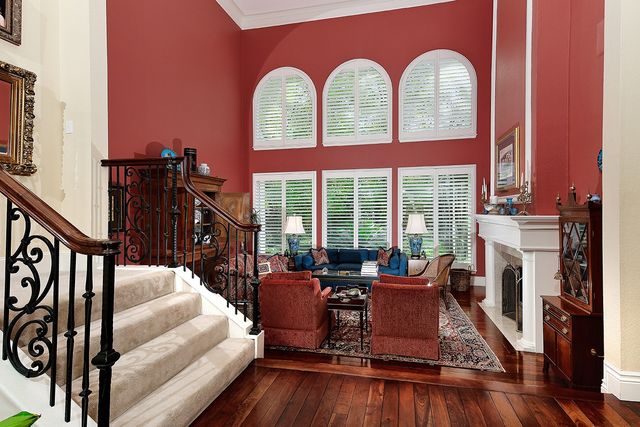 a living room with furniture a large window and a fireplace