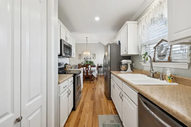 a kitchen with stainless steel appliances granite countertop lots of counter top space and cabinets