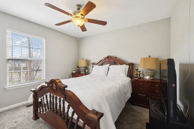 a bedroom with a bed and a chandelier
