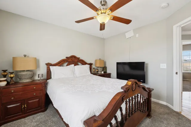 a bedroom with a bed and a flat screen tv