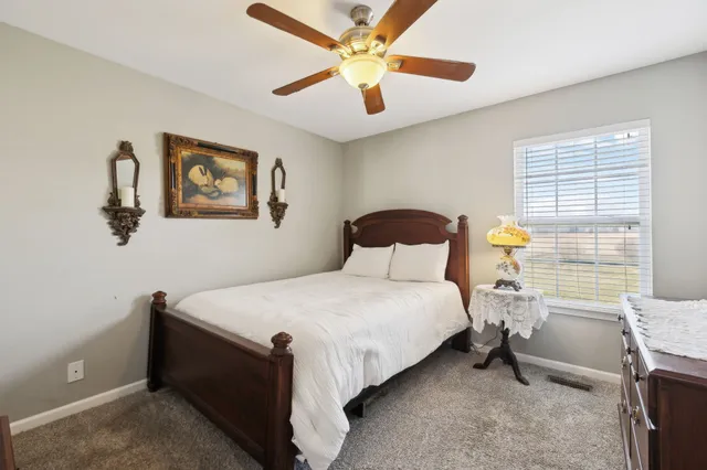 a bedroom with a bed and a table