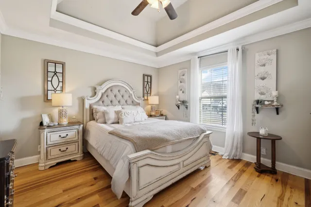 a bedroom with a bed and a chandelier