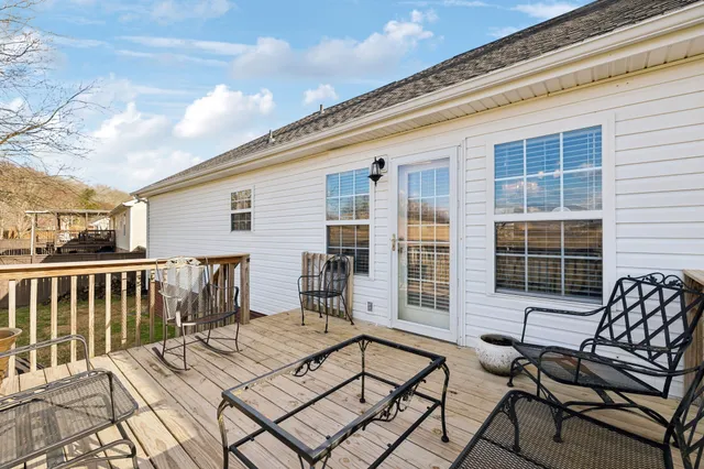 a view of a patio with a dining table and chairs with wooden floor