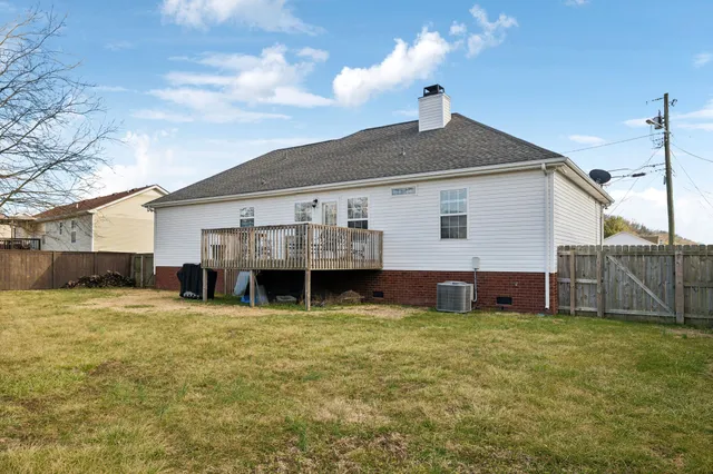 a view of a house with a yard and sitting area