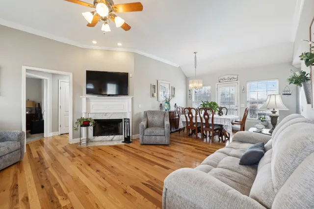 a living room with furniture a fireplace and a flat screen tv