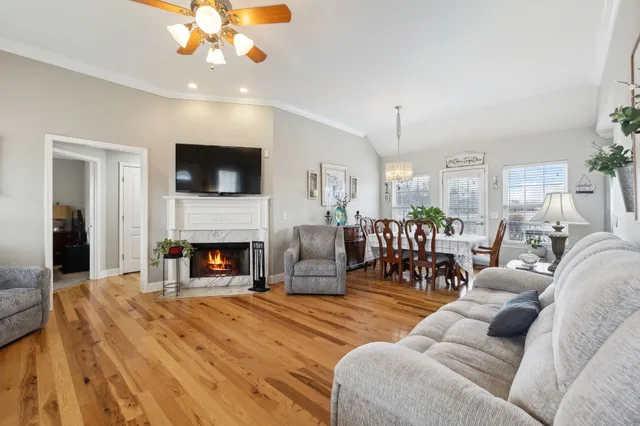 a living room with furniture a fireplace and a flat screen tv