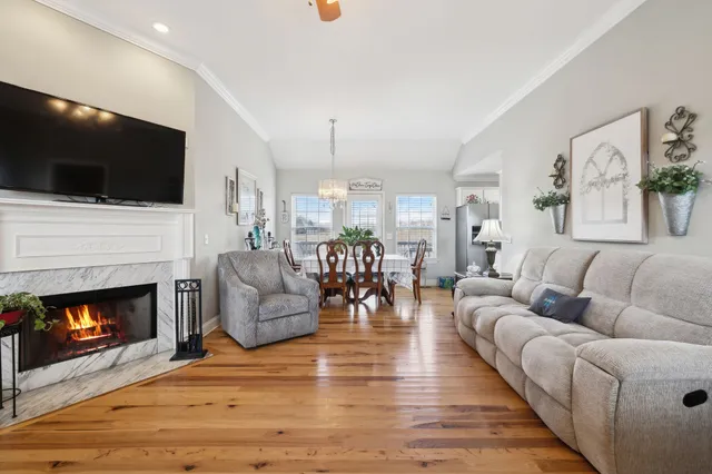 a living room with furniture fireplace and flat screen tv