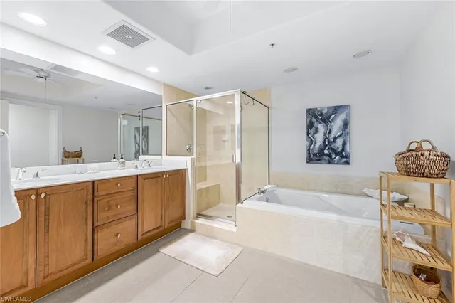 a spacious bathroom with a tub sink and mirror