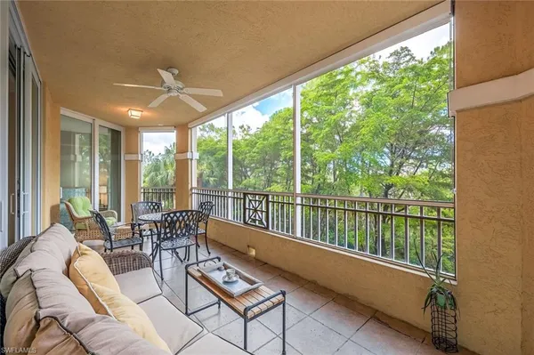 a living room with furniture and floor to ceiling windows
