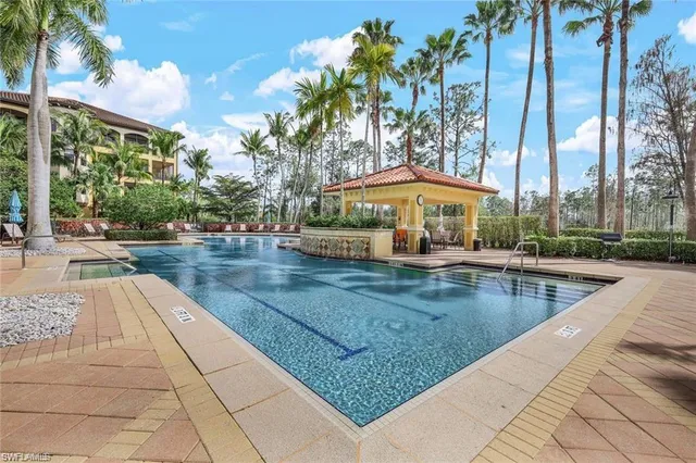 a view of swimming pool with outdoor seating and plants