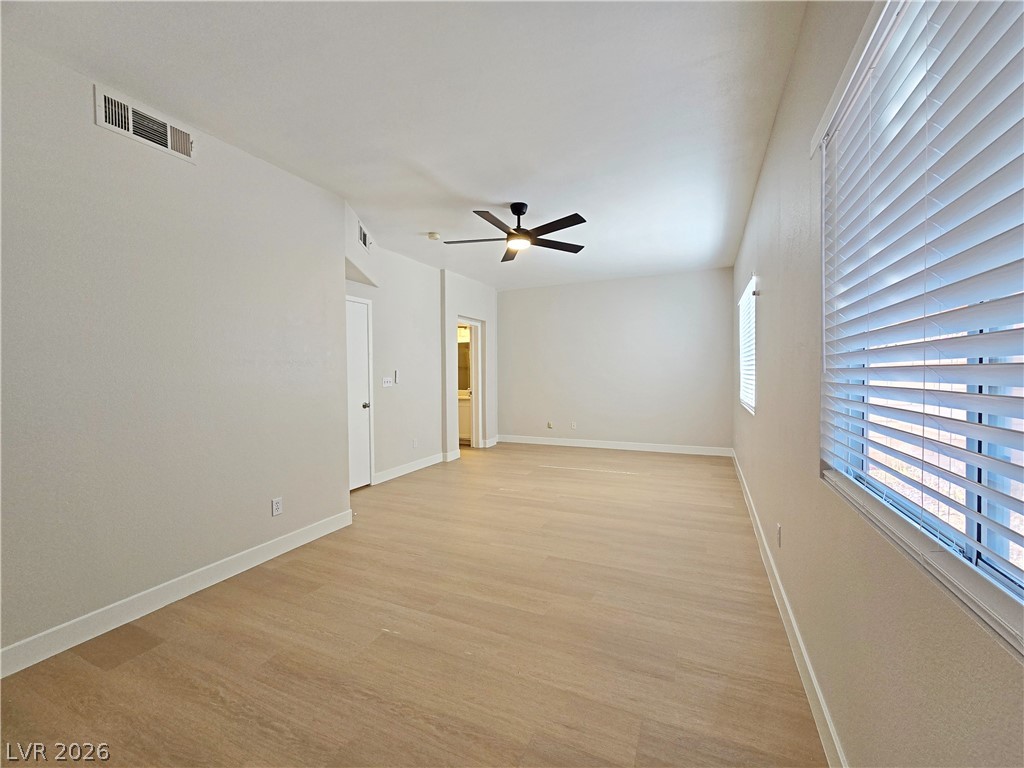 5370 Runningbrook Road Las Vegas, NV 89120 - Photo 20 of 30 A spacious, naturally illuminated room features a modern ceiling fan and durable flooring.