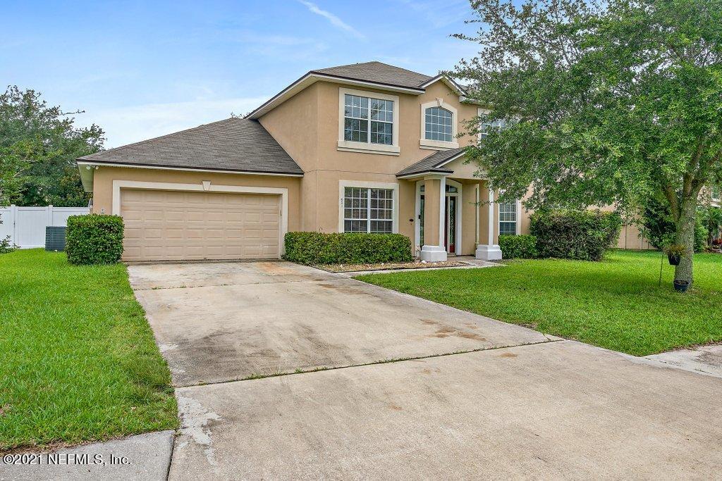 621 East Red House Branch Road St. Augustine, FL 32084 - Photo 1 of 47 a front view of a house with a yard and garage