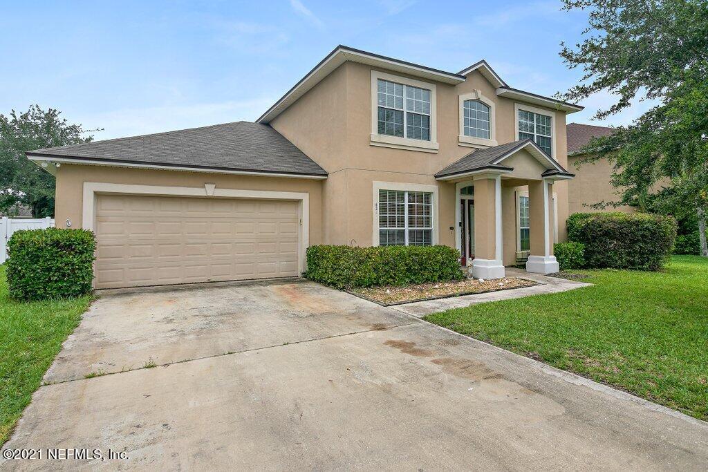 621 East Red House Branch Road St. Augustine, FL 32084 - Photo 4 of 47 a front view of a house with a yard and garage
