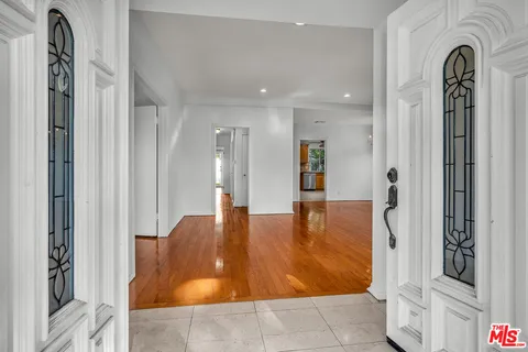 a view of empty room with wooden floor and fireplace