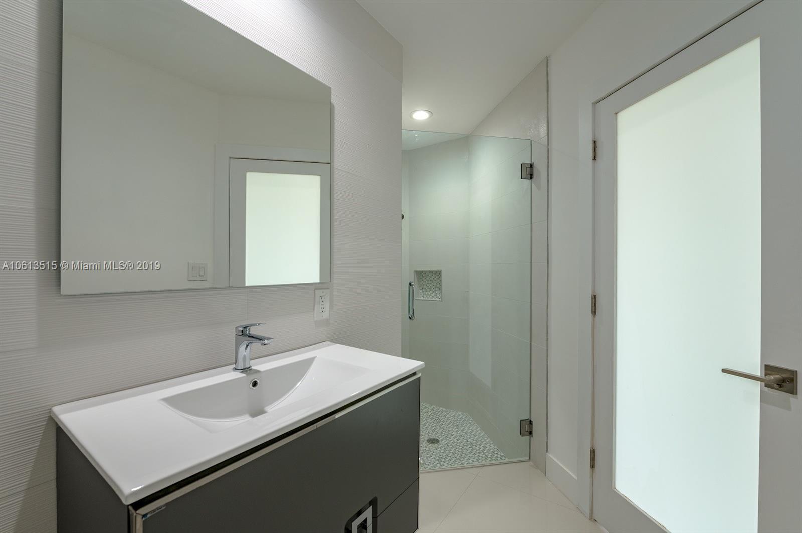 561 Ranch Road Weston, FL 33326 - Photo 12 of 46 a bathroom with a sink and a mirror