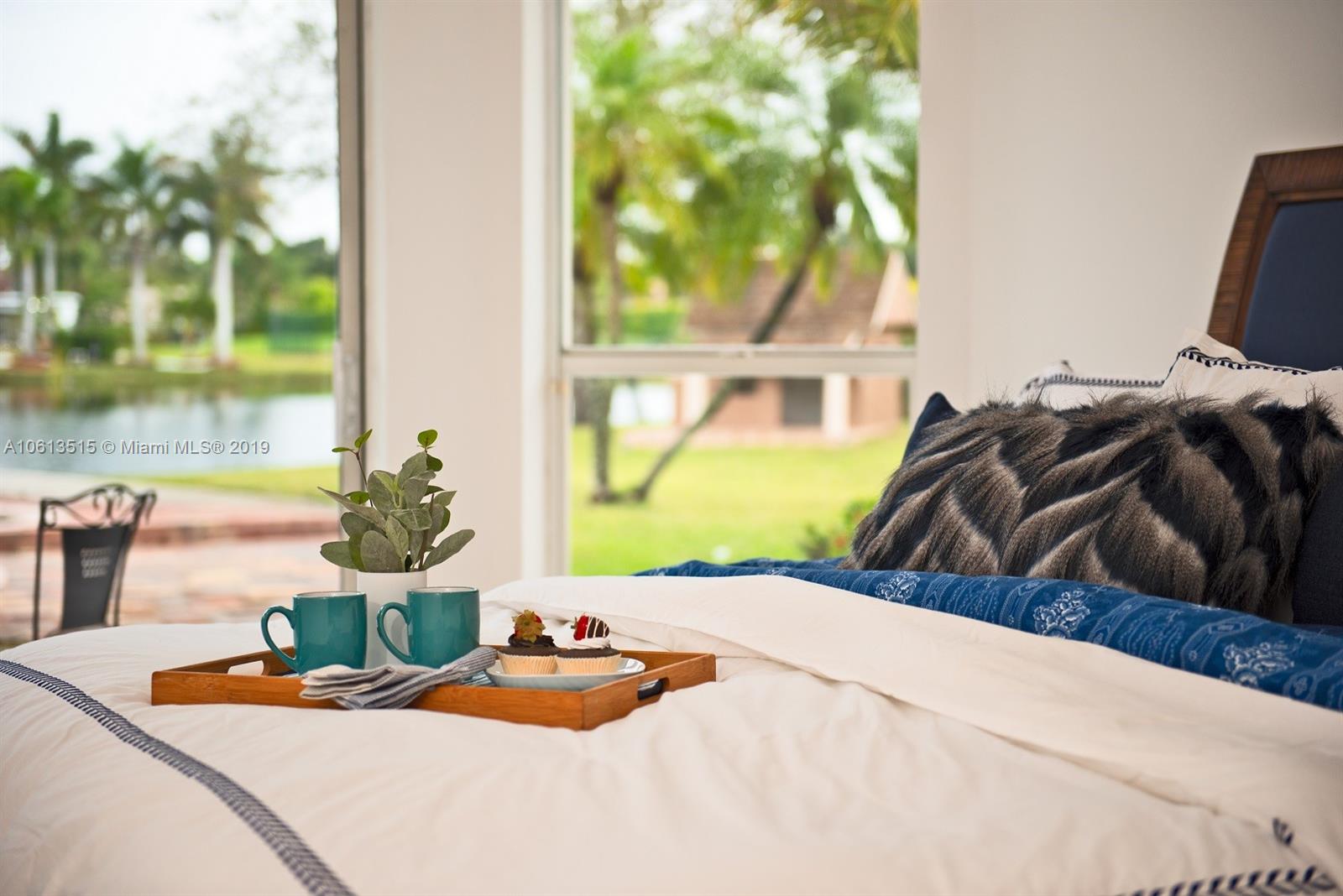 561 Ranch Road Weston, FL 33326 - Photo 15 of 46 a bedroom with a bed and a painting on the wall