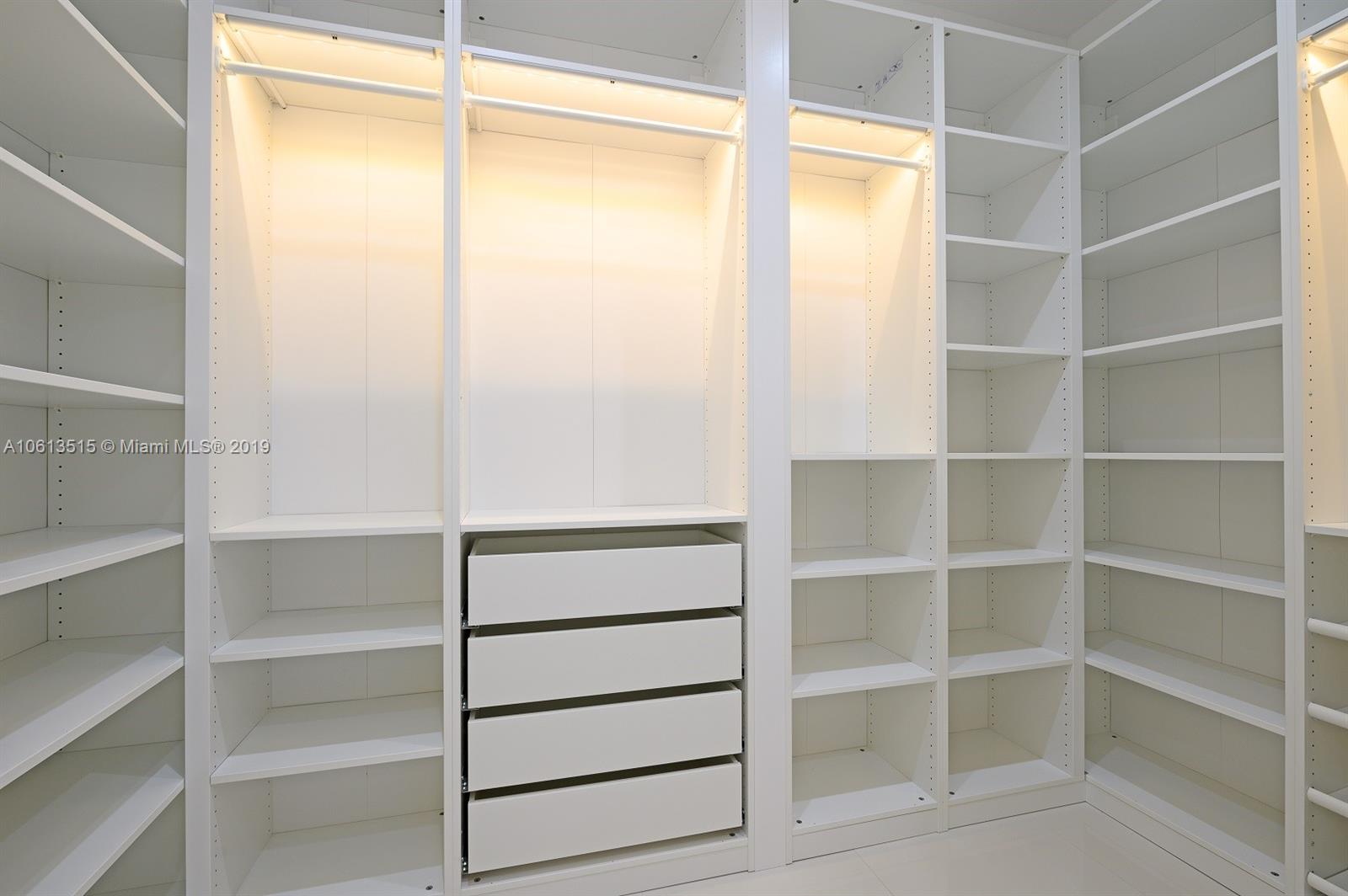 561 Ranch Road Weston, FL 33326 - Photo 16 of 46 a view of walk in closet with empty racks