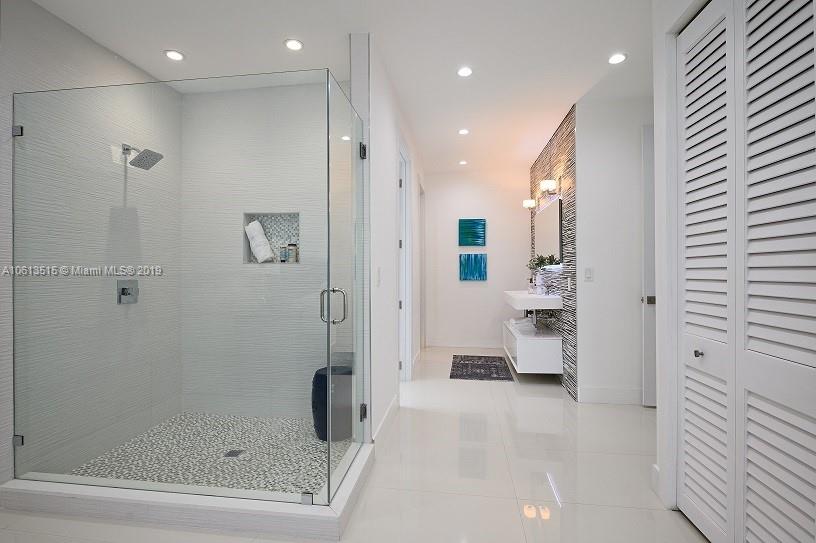561 Ranch Road Weston, FL 33326 - Photo 18 of 46 a bathroom with a glass shower door