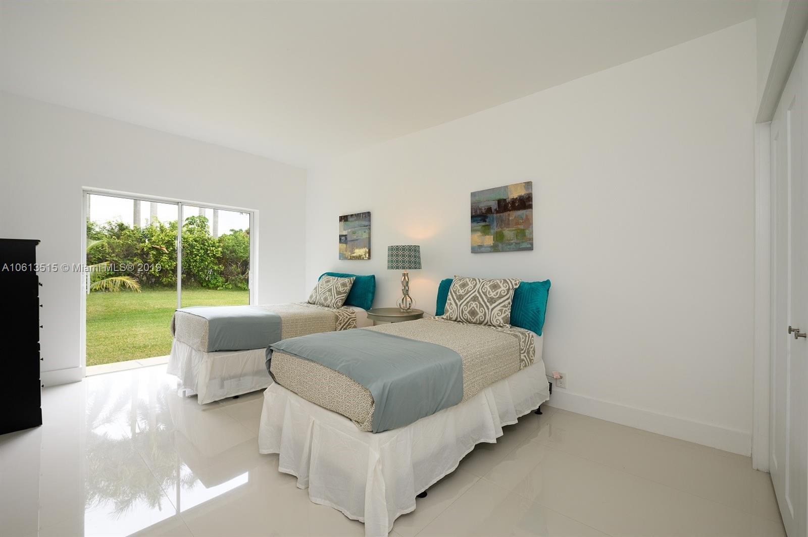 561 Ranch Road Weston, FL 33326 - Photo 21 of 46 a spacious bedroom with a bed and a couch