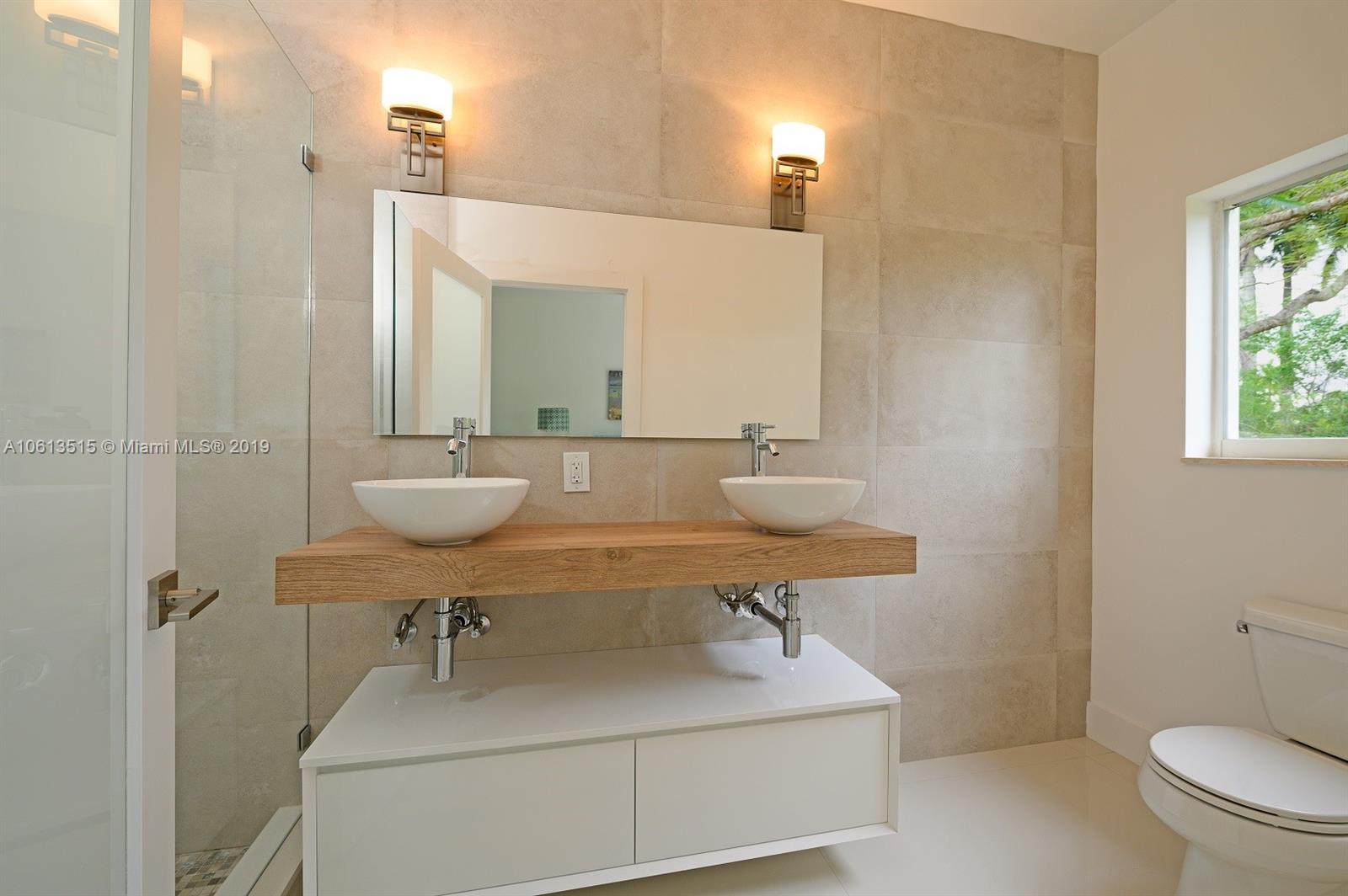 561 Ranch Road Weston, FL 33326 - Photo 25 of 46 a bathroom with a sink a toilet and mirror