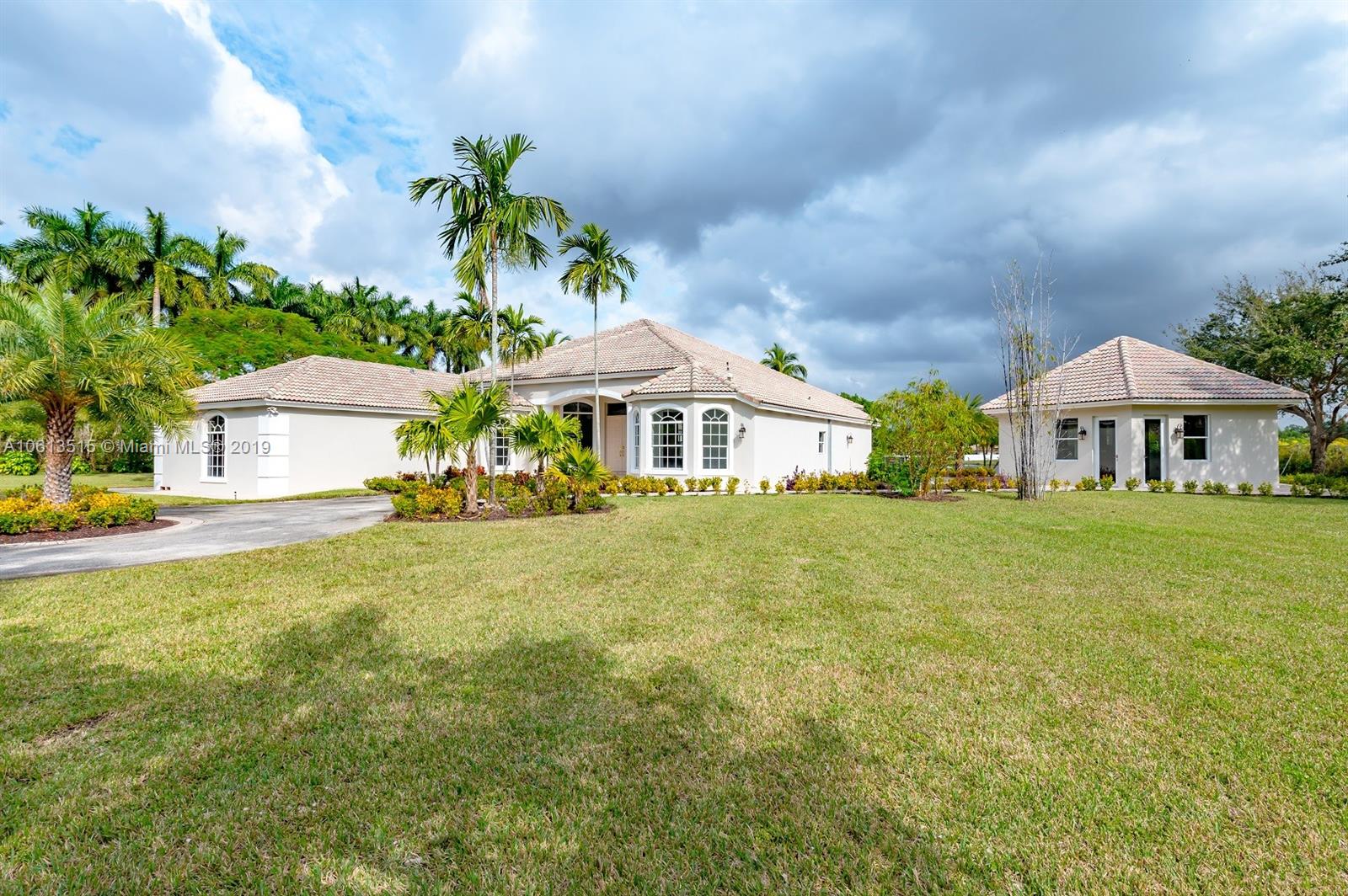 561 Ranch Road Weston, FL 33326 - Photo 29 of 46 a front view of a house with a garden