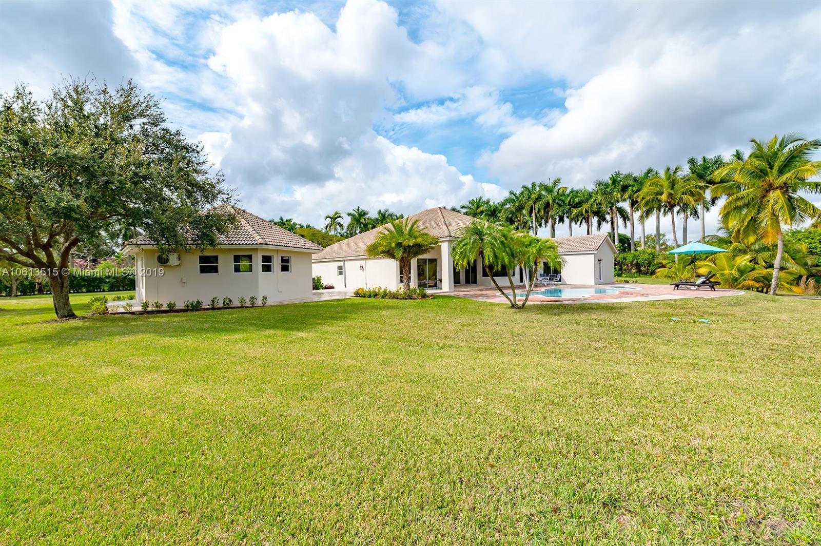 561 Ranch Road Weston, FL 33326 - Photo 30 of 46 a view of a swimming pool with an outdoor space and seating area