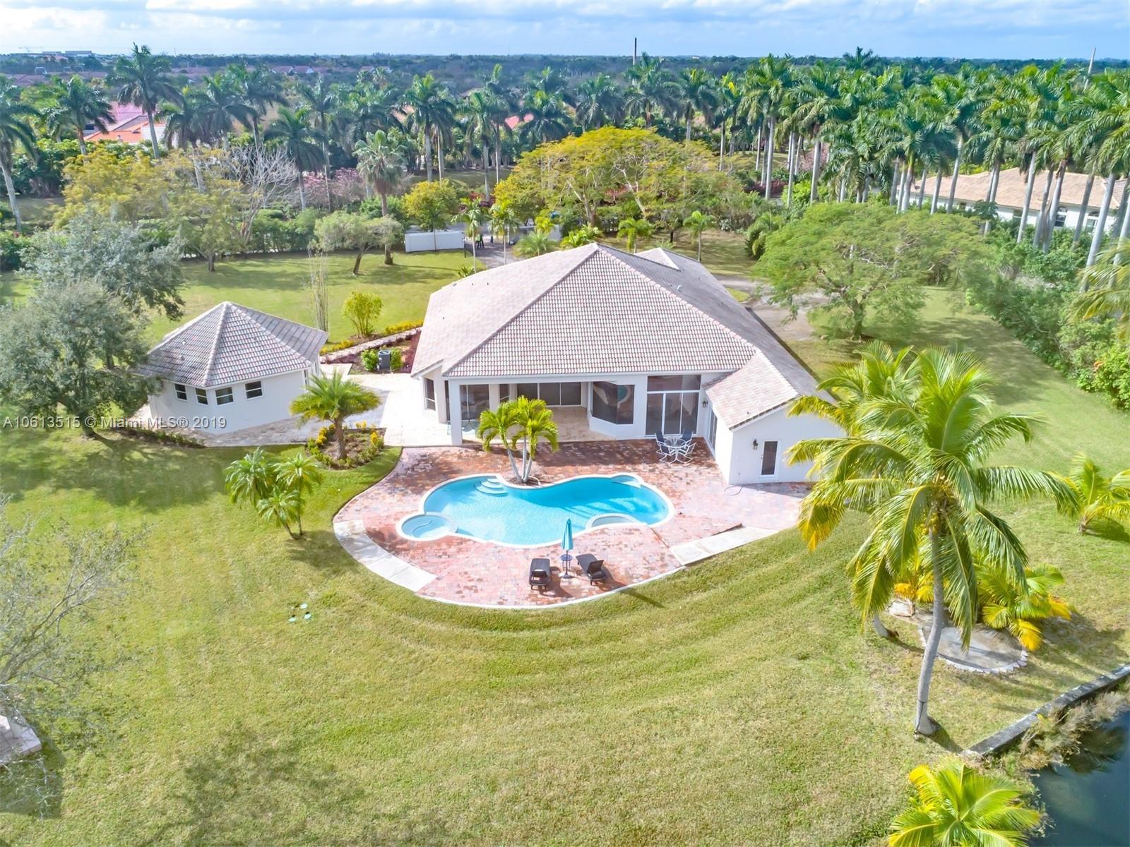 561 Ranch Road Weston, FL 33326 - Photo 32 of 46 a view of a swimming pool with a yard