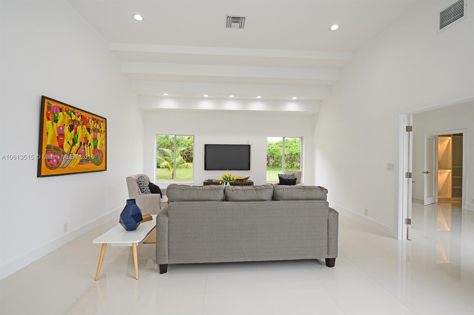 561 Ranch Road Weston, FL 33326 - Photo 7 of 46 a living room with furniture a flat screen tv and a large window
