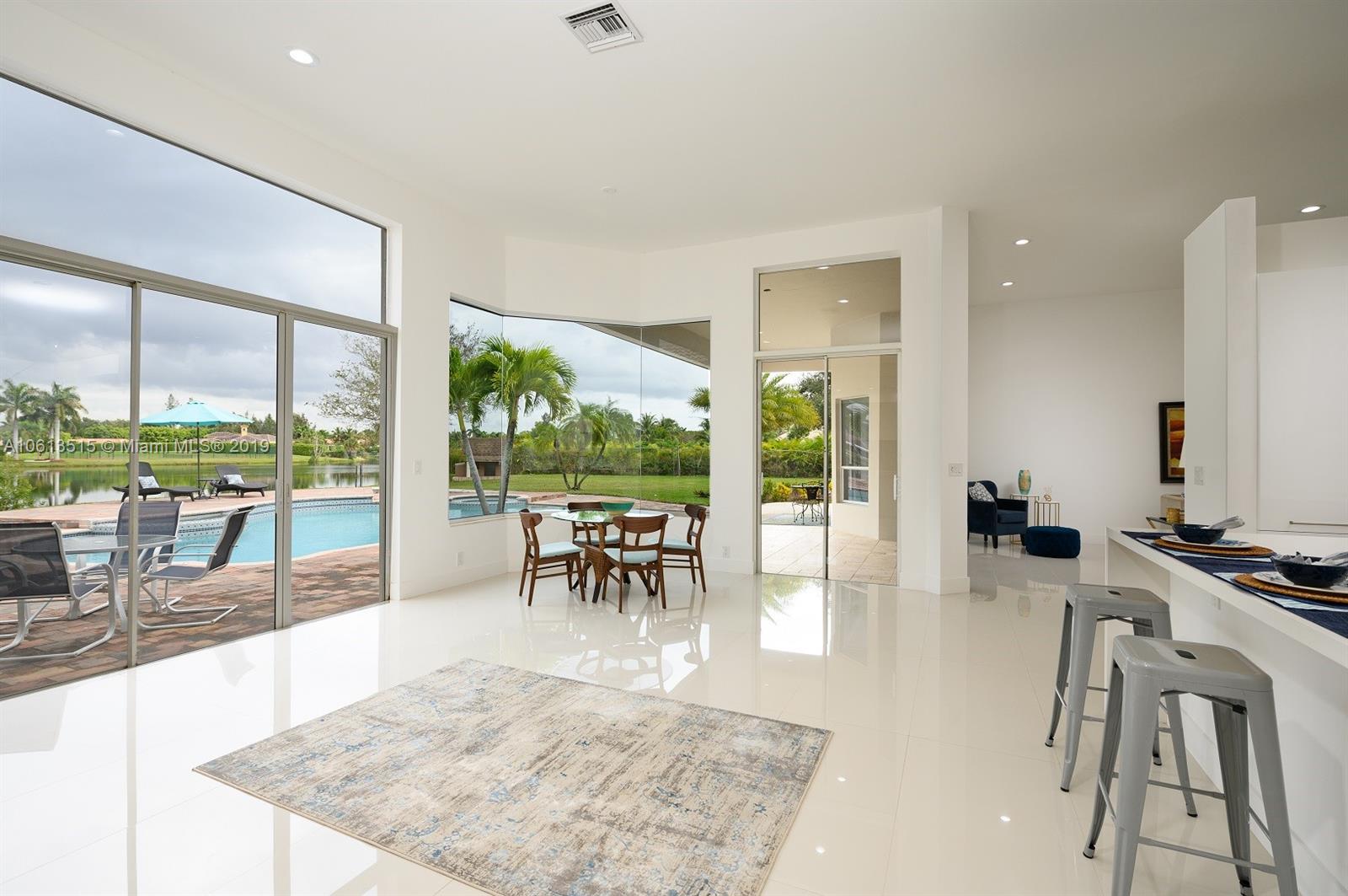 561 Ranch Road Weston, FL 33326 - Photo 8 of 46 a view of a living room and floor to ceiling window or kitchen