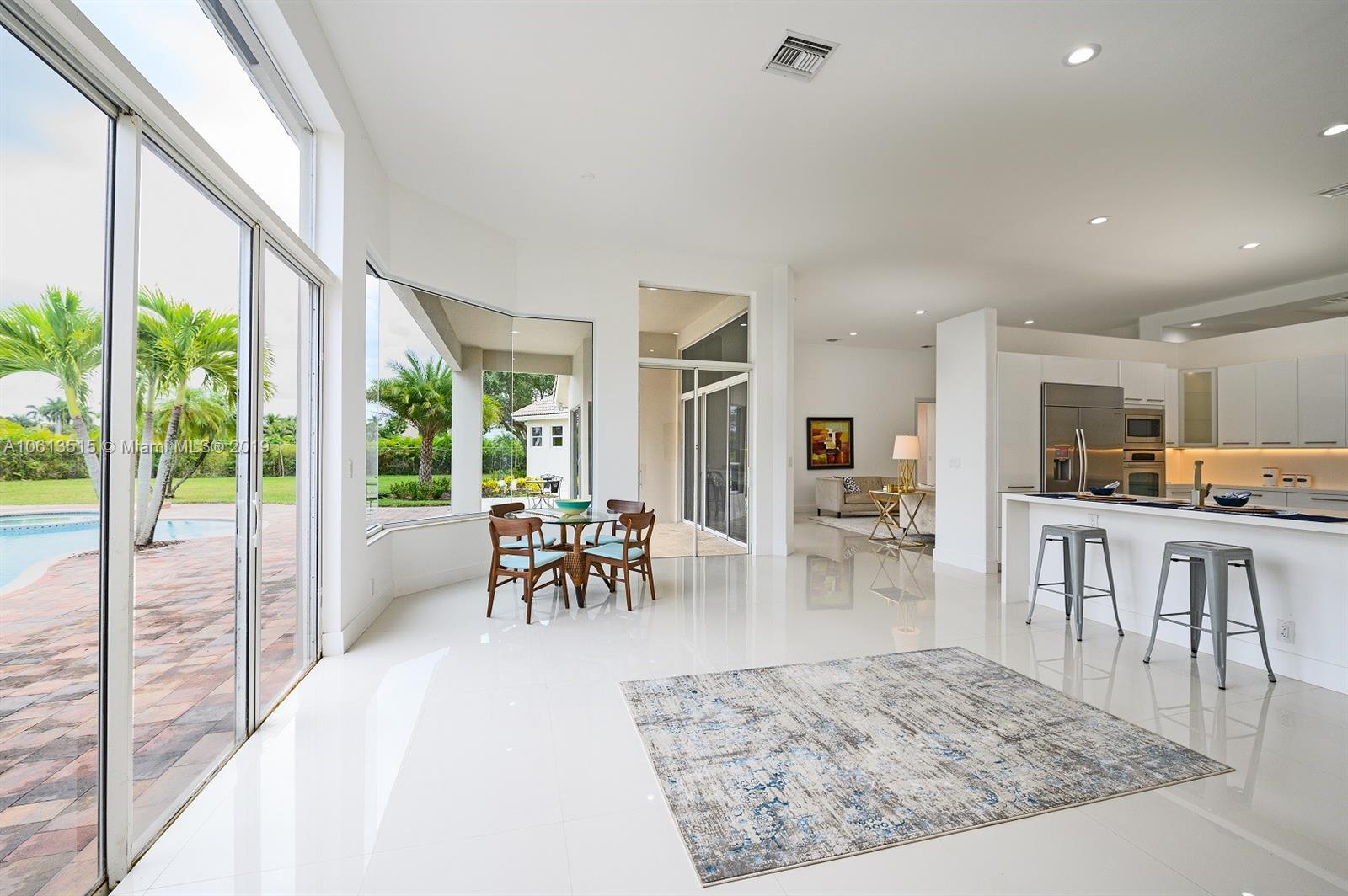 561 Ranch Road Weston, FL 33326 - Photo 9 of 46 a view of a living room and dining room