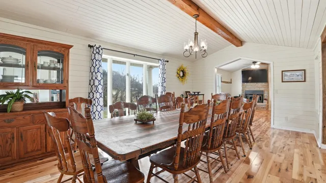 a view of a dining room with furniture and chandelier