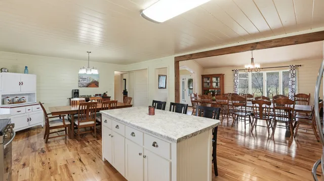 a kitchen with granite countertop white cabinets and a sink